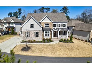 Charming two-story home with brick and stone accents, complemented by a well-manicured lawn at 1775 Rockwater Rd, Marietta, GA 30066