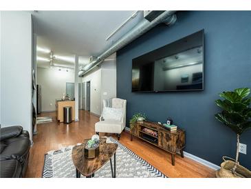 Inviting living room features hardwood floors, stylish decor, and a modern entertainment center at 5300 Peachtree Rd # 503, Atlanta, GA 30341