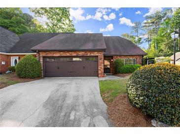 Brick home featuring an attached two car garage and beautifully maintained landscaping at 6 Westchester Sq, Decatur, GA 30030