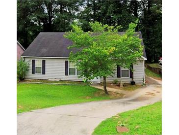 Charming single-story home with gray siding, a well-maintained lawn, and a concrete driveway at 9161 Fairway Ct, Riverdale, GA 30274