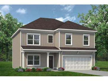 Charming two-story home with neutral siding, a manicured lawn, and a two-car garage at 106 Asher Dr, Carrollton, GA 30116