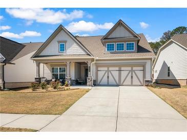 Charming, Craftsman-style home with a well-manicured lawn, covered porch and two car garage in a desirable neighborhood at 2638 Songbird Ln, Grayson, GA 30017