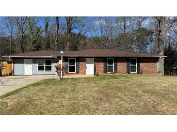 Charming single-story home featuring a brick facade and well-maintained front yard, perfect for suburban living at 781 E Glochester Pl, Norcross, GA 30071