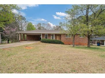 Charming brick ranch home with a covered carport and well-maintained landscaping at 3355 Lauada Dr, Douglasville, GA 30135