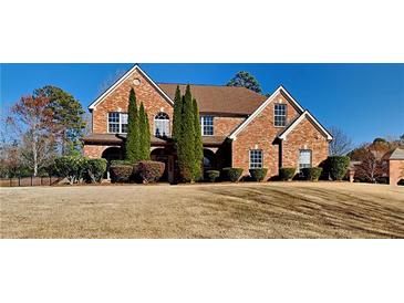 Beautiful two-story brick home with mature landscaping and a well-manicured lawn at 2413 Brynlynn Woods, Conyers, GA 30013