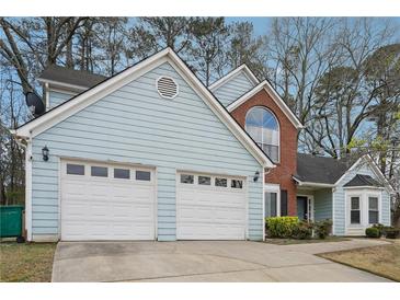 Charming home featuring a two-car garage, light blue siding, and brick accents at 2770 Da Vinci Cres, Decatur, GA 30034
