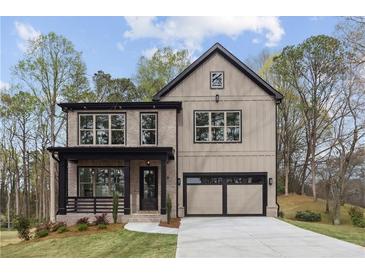 Charming home featuring a brick facade, a covered porch, and an attached garage at 346 Langford Dr, Norcross, GA 30071