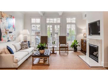 Bright living room features a fireplace, large windows, and comfortable seating at 45 Honour Nw Ave, Atlanta, GA 30305