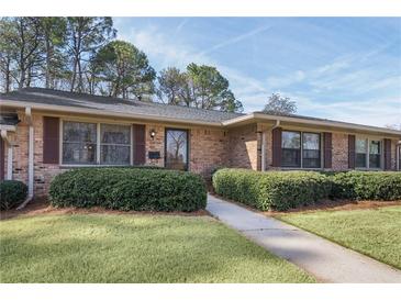 Charming single-story brick home featuring well-maintained landscaping and a welcoming entrance at 3346 Stonecrest Ct, Atlanta, GA 30341