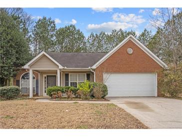 Charming one-story home featuring a combination of brick and siding, lush landscaping, and an attached two-car garage at 2279 Perch Sw Way, Marietta, GA 30008