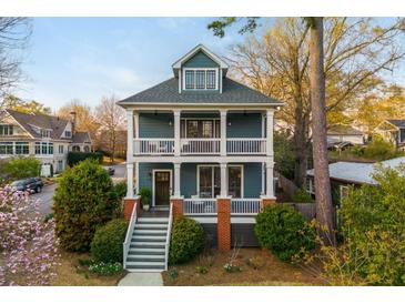 Charming two-story home with a double front porch, a yard, and beautiful landscaping at 243 Sterling St, Decatur, GA 30030