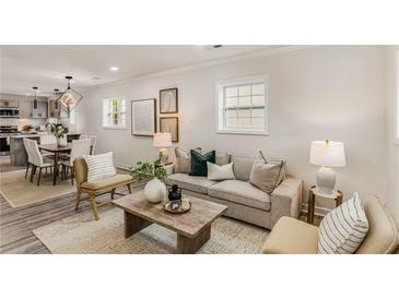 Cozy living room featuring neutral tones, stylish decor, and an open layout connecting to the dining area and kitchen at 1062 Grant Terrace, Atlanta, GA 30315