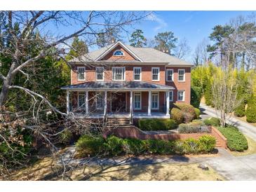 Charming brick home with a inviting front porch and beautifully landscaped front yard at 1364 Manget Way, Dunwoody, GA 30338