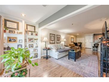 Inviting living room with hardwood floors, built-in shelving, and plenty of natural light at 3201 Lenox Ne Rd # 16, Atlanta, GA 30324