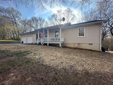 Charming single-story home featuring a welcoming front porch and a well-maintained, spacious front yard at 7503 E Cherokee Dr, Canton, GA 30115