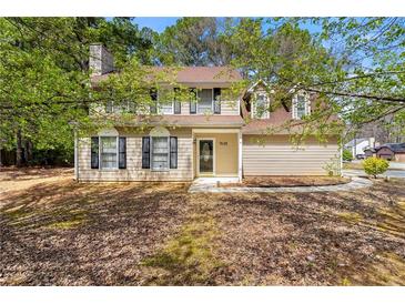 Charming two-story home featuring a well-maintained lawn and inviting front entrance at 7438 Chilton Ln, Riverdale, GA 30296