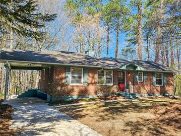 Charming brick home with a covered parking area and well-maintained front lawn at 2194 Willivee Pl, Decatur, GA 30033