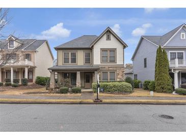 Charming two-story home featuring a stone facade and a cozy front porch, perfect for relaxing outdoors at 3919 Teal Cir, Powder Springs, GA 30127