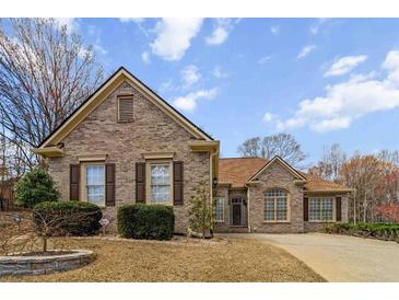 Charming single-story brick home with manicured landscaping and a well-maintained lawn, perfect for suburban living at 3211 Blaisdell Rd, Buford, GA 30519
