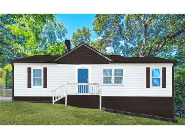 Charming one-story home with a blue door, dark shutters, and landscaped front yard at , Atlanta, GA 30315