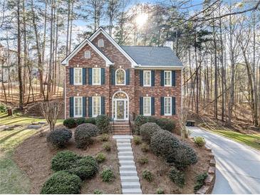 Beautiful two-story brick home featuring lush landscaping and a private driveway at 2285 Briarwood Trl, Cumming, GA 30041