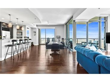 Bright living room with floor-to-ceiling windows and an open floor plan with modern finishes and balcony access at 270 17Th Nw St # 4208, Atlanta, GA 30363