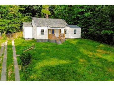 Charming single-Gathering home features a covered porch with a well-maintained lawn and driveway at 451 Collier Ridge Dr, Atlanta, GA 30318