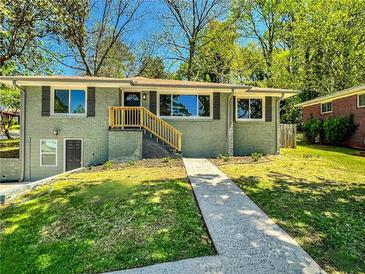 Charming renovated single-story home with modern gray paint, dark shutters, and a freshly landscaped front yard at 147 Hermer Nw Cir, Atlanta, GA 30311