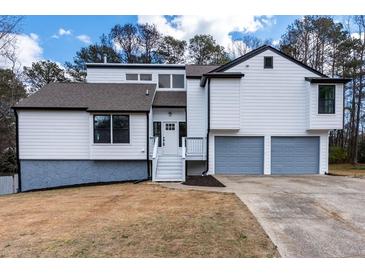 Charming two-story home boasts a clean white exterior, gray trim, and a two-car garage at 2562 Tritt Springs Ne Trce, Marietta, GA 30062