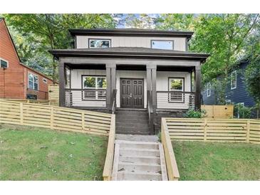 Charming two-story home boasts a welcoming front porch, modern design, and manicured lawn, perfect for suburban living at 99 Brown Ave, Atlanta, GA 30315