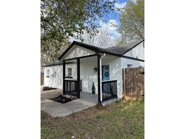 Charming home featuring a covered front porch with black trim and a welcoming blue front door at 1076 Grant Se Way, Atlanta, GA 30315