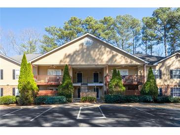 Charming two-story condo with manicured landscaping, covered decks, and ample parking spaces at 106 Brighton Pt, Atlanta, GA 30328