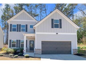 Charming two-story home featuring a grey siding, black shutters, and a convenient two-car garage at 2099 Easterwood Ter, Decatur, GA 30032
