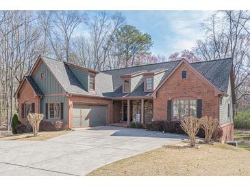 Charming brick home with a well-manicured lawn and an attached two-car garage at 1765 Dew Pl, Marietta, GA 30064