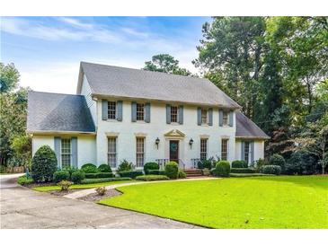 Stately two-story home with a manicured lawn, beautiful landscaping, and traditional architectural details at 3200 Farmington, Vinings, GA 30339
