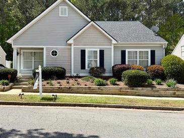 Charming single-story home with manicured landscaping and gray siding at 3775 Pine Village Pl, Loganville, GA 30052