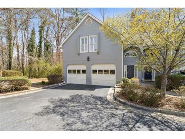 Charming home with two-car garage, mature trees, and well-maintained landscaping at 3923 Ashford Lake Ne Ct, Brookhaven, GA 30319