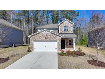 Charming two-story home with brick accents and a well-manicured front yard, perfect for a Gathering at 1659 Hay Patch Ln, Loganville, GA 30052
