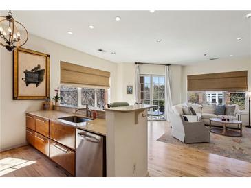 Bright, open concept kitchen flows into the living area with hardwood floors and modern finishes at 1430 Dresden Ne Dr # 200, Atlanta, GA 30319