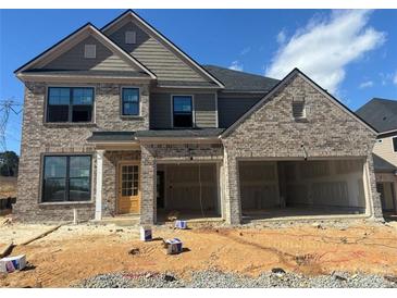 New two-story brick home featuring a large 3-car garage and stylish architectural details at 4190 Hosch Reserve Dr, Buford, GA 30519