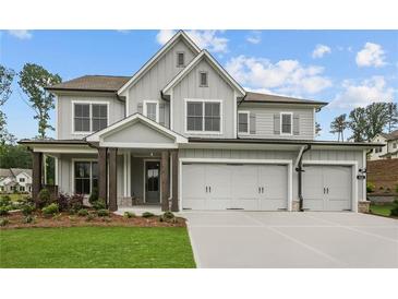 Beautiful two-story home with a three-car garage and a welcoming front porch at 444 Lower Shoreline Ct Sw, Marietta, GA 30064