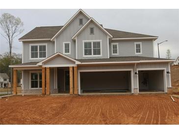 Charming two-story home featuring a three-car garage, a covered front porch, and modern farmhouse-style architecture at 444 Lower Shoreline Ct Sw, Marietta, GA 30064