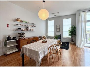 Bright and airy living room with modern furnishings, shelving, and access to a balcony at 2630 Talley St # 426, Decatur, GA 30030