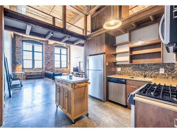 Modern kitchen features stainless steel appliances, mosaic backsplash, and mobile island at 170 Boulevard Se # 421 H, Atlanta, GA 30312