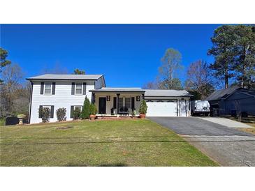 Charming two-story home featuring a spacious yard and attached garage, perfect for comfortable living at 3007 Hidden Dr, Lawrenceville, GA 30044