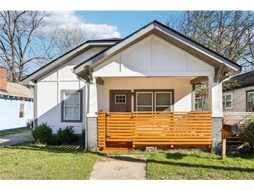 Charming home with a cozy front porch and modern wooden slats for added privacy and curb appeal at 793 Joseph E Boone Nw Blvd, Atlanta, GA 30314