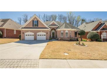 Charming one-story brick home featuring a two-car garage and well-manicured front lawn at 1913 Shenley Park Ln, Duluth, GA 30097