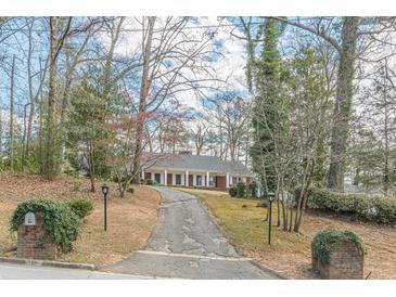 Traditional brick home with a long driveway and a well-maintained front yard landscape at 3390 Somerset Sw Trl, Atlanta, GA 30331