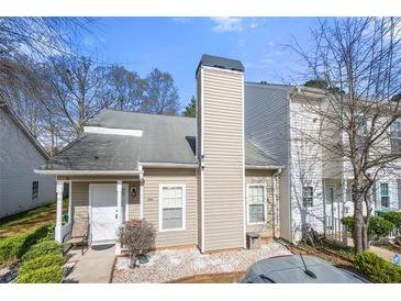 Charming townhome with a well-maintained front yard, white door, and neutral siding at 6450 Wellington Chase Ct, Lithonia, GA 30058