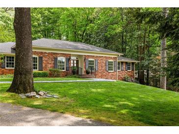 Charming brick home with a well-manicured lawn and mature trees offering great curb appeal at 4183 Paran Pines Nw Dr, Atlanta, GA 30327
